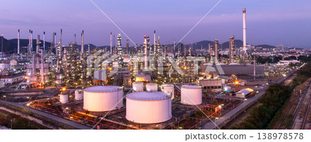 Aerial view oil and gas petrochemical storage tank with oil and gas refinery plant at twilight, Global business power and energy petrochemical industry, Oil and gas refinery petrochemical industrial. 138978578