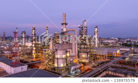 Aerial view oil and gas petrochemical storage tank with oil and gas refinery plant at twilight, Global business power and energy petrochemical industry, Oil and gas refinery petrochemical industrial. 138978579