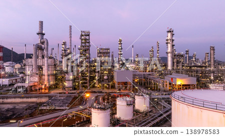 Aerial view oil and gas petrochemical storage tank with oil and gas refinery plant at twilight, Global business power and energy petrochemical industry, Oil and gas refinery petrochemical industrial. 138978583