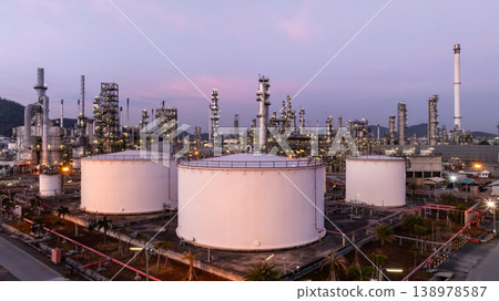 Aerial view oil and gas petrochemical storage tank with oil and gas refinery plant at twilight, Global business power and energy petrochemical industry, Oil and gas refinery petrochemical industrial. 138978587
