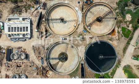 Aerial view wastewater treatment plant. Circular sedimentation tanks biological reactor, Water cleaning facility wastewater treatment plant, Recirculation solid contact clarifier sedimentation tank. Aerial view wastewater treatment plant. Circular sedimentation tanks biological reactor, Water cleaning facility wastewater treatment plant, Recirculation solid contact clarifier sedimentation tank. 138978591