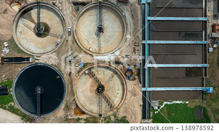 Aerial view wastewater treatment plant. Circular sedimentation tanks biological reactor, Water cleaning facility wastewater treatment plant, Recirculation solid contact clarifier sedimentation tank. Aerial view wastewater treatment plant. Circular sedimentation tanks biological reactor, Water cleaning facility wastewater treatment plant, Recirculation solid contact clarifier sedimentation tank. 138978592