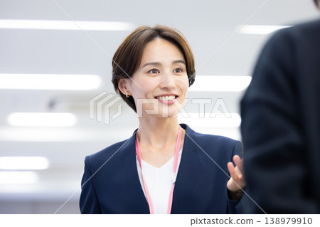 一位女士在商務場合與同事交談。 一位女士在商務場合與同事交談。 138979910