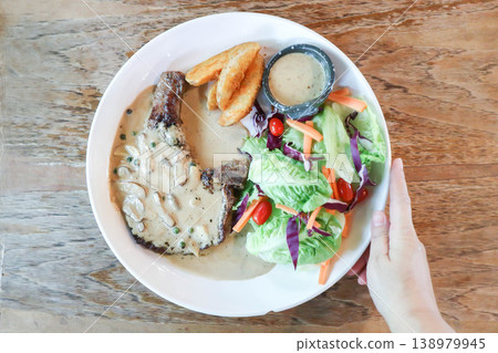 pork steak or grilled pork and salad or pork chop and vegetable pork steak or grilled pork and salad or pork chop and vegetable 138979945