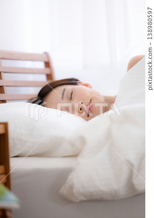 Woman sleeping soundly in bed Woman sleeping soundly in bed 138980597