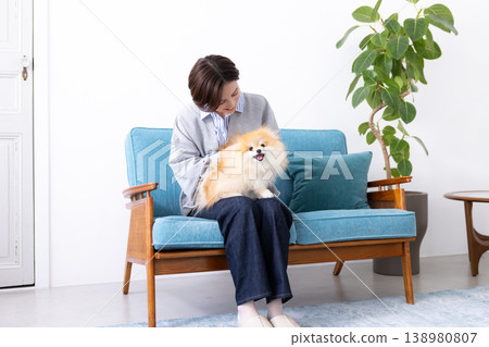 Lifestyle: A woman holding her pet dog 138980807