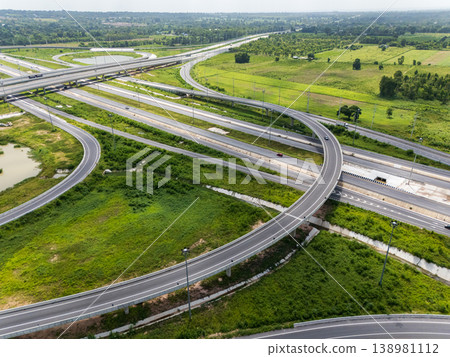 Drone shot a large highway interchange crossing over green farmlands in Thailand Drone shot a large highway interchange crossing over green farmlands in Thailand 138981112