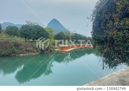 The karst mountains and the sky, reflected in the river in Yangshou, China The karst mountains and the sky, reflected in the river in Yangshou, China 138982746