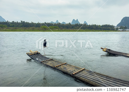 Landscape in Yangshuo Guilin, China Cormorant bird a bamboo raft Landscape in Yangshuo Guilin, China Cormorant bird a bamboo raft 138982747