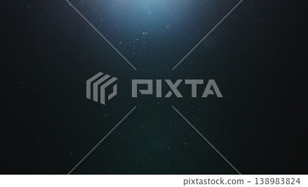 dust particles floating mid air over dark background with some lens flare 138983824