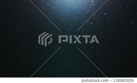 dust particles floating mid air over dark background with some lens flare 138983826