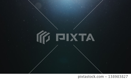 dust particles floating mid air over dark background with some lens flare 138983827