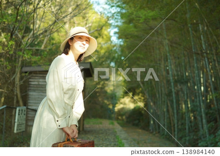 A woman waiting for a train at her hometown station. 138984140