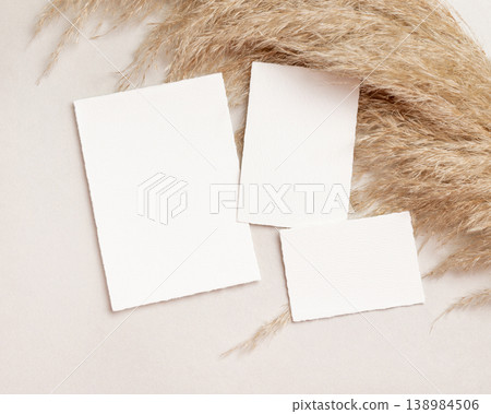 Blank portrait cards set mockup on beige stone with pampas grass top view, boho wedding stationery Blank portrait cards set mockup on beige stone with pampas grass top view, boho wedding stationery 138984506