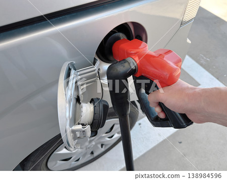 Image of your hands refueling at a gas station Image of your hands refueling at a gas station 138984596