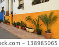 Colorful Spanish Street with White and Orange House Facade, Potted Plants and Mediterranean Charm 138985065