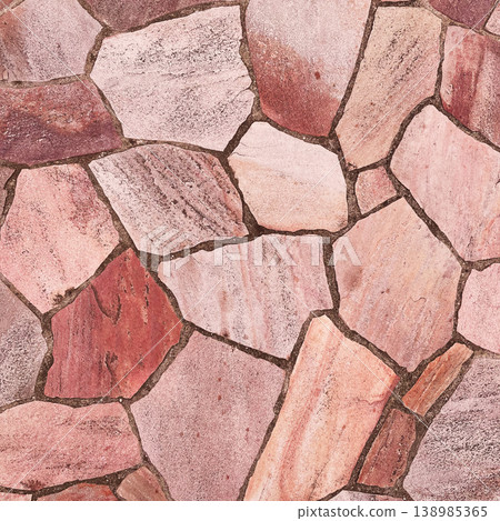 A square background image of the surface of irregularly shaped paving stones in a light reddish-brown pattern. A square background image of the surface of irregularly shaped paving stones in a light reddish-brown pattern. 138985365