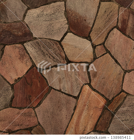 Square background image of a surface with light brown, irregularly shaped paving stones. 138985411