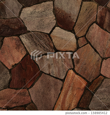 Square background image of the surface of irregularly shaped brown paving stones. 138985412