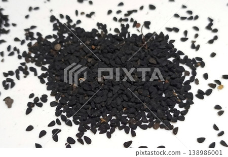 Black cumin seeds pile isolated on white background Black cumin seeds pile isolated on white background 138986001