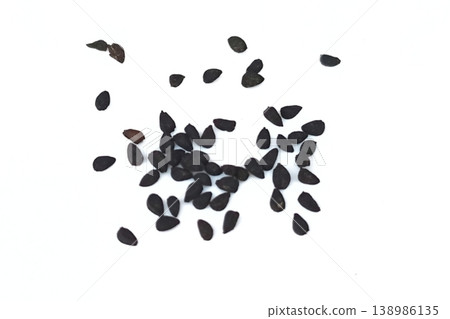 Black cumin seeds pile isolated on white background Black cumin seeds pile isolated on white background 138986135