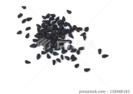 Black cumin seeds pile isolated on white background Black cumin seeds pile isolated on white background 138986165