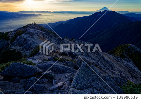 A view of the Kofu Basin, Mt. Fuji, and Mt. Houou from the summit of Mt. Kaikomagatake, bathed in the morning sun. A view of the Kofu Basin, Mt. Fuji, and Mt. Houou from the summit of Mt. Kaikomagatake, bathed in the morning sun. 138986539