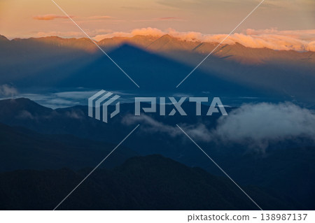 The shadow of Mount Kai-Komagatake reflected in the mountain range of the Central Alps. The shadow of Mount Kai-Komagatake reflected in the mountain range of the Central Alps. 138987137