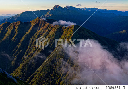 Dawn over Mt. Kitadake, Mt. Ainodake, Mt. Shiomidake, and Mt. Arakawadake as seen from Mt. Kai-Komagatake. Dawn over Mt. Kitadake, Mt. Ainodake, Mt. Shiomidake, and Mt. Arakawadake as seen from Mt. Kai-Komagatake. 138987145