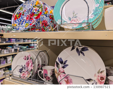 Floral ceramic plates and mugs on retail store shelf Floral ceramic plates and mugs on retail store shelf 138987321