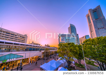 Yokohama cityscape, Japan, April 18th. View of Sakuragicho Station, Yokohama Landmark Tower, and freight trains bathed in the setting sun. Yokohama cityscape, Japan, April 18th. View of Sakuragicho Station, Yokohama Landmark Tower, and freight trains bathed in the setting sun. 138987658
