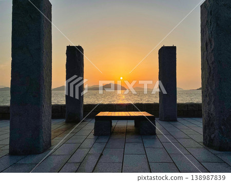 Stone pillars and benches on the beach overlooking the sunset Stone pillars and benches on the beach overlooking the sunset 138987839