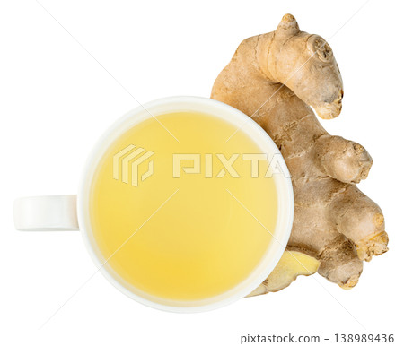 Top view of a white mug filled with hot ginger tea next to a fresh raw ginger root. Healthy herbal beverage for wellness and cold relief isolated. Studio overhead macro shot. Top view of a white mug filled with hot ginger tea next to a fresh raw ginger root. Healthy herbal beverage for wellness and cold relief isolated. Studio overhead macro shot. 138989436