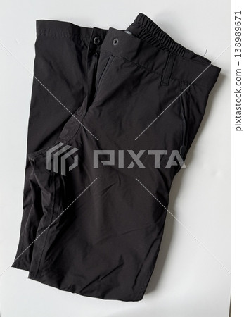Black pants on a plain white surface for fashion and clothing design background Black pants on a plain white surface for fashion and clothing design background 138989671