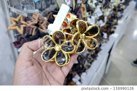 Yogyakarta, Indonesia - March 18th 2026 - Vibrant Minimalist gold flower hair clips on display Yogyakarta, Indonesia - March 18th 2026 - Vibrant Minimalist gold flower hair clips on display 138990126
