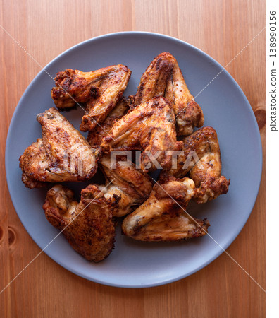 grilled chicken wings on a grey plate. 138990156