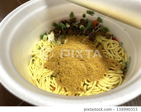 Cup noodles before adding hot water, with powdered soup and dried toppings already added. Cup noodles before adding hot water, with powdered soup and dried toppings already added. 138990353