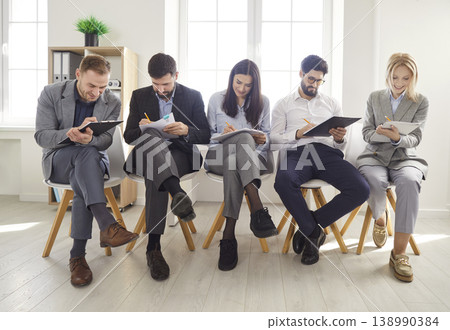 Diverse people on chairs in row waiting in queue for job interview turn in office, applicants 138990384