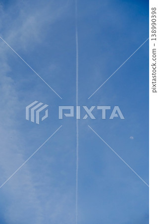 An airplane cloud extending into the blue sky An airplane cloud extending into the blue sky 138990398