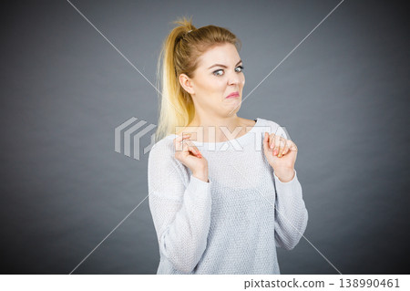 Disgusted woman having funny face expression Disgusted woman having funny face expression 138990461
