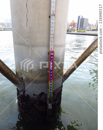 The scale markings at the Reiganjima tide gauge station and water level gauge site, a local historical site in Chuo Ward, Tokyo, and the Sumida River The scale markings at the Reiganjima tide gauge station and water level gauge site, a local historical site in Chuo Ward, Tokyo, and the Sumida River 138990517