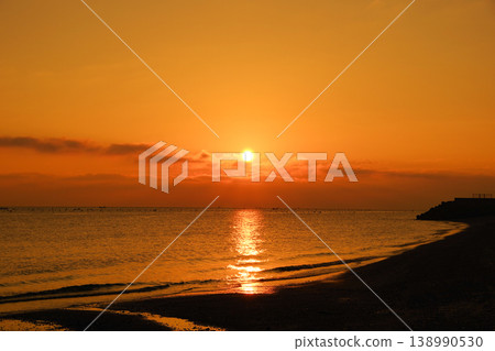 The sea, the sunrise, and the sky painted orange. The sea, the sunrise, and the sky painted orange. 138990530