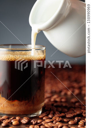 Cream is added to the coffee. Cream is added to the coffee. 138990969
