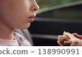 little girl child eating burger in car, happy person, Joyful kid traveler, eating while buckled up, burger time in car, roadside hunger, fresh air and food, travel companion, young one s delight 138990991