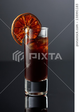 Coffee liquor with ice in tall glass. 138991183