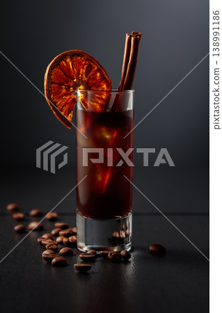 Coffee liquor with ice in tall glass on a black background. 138991186