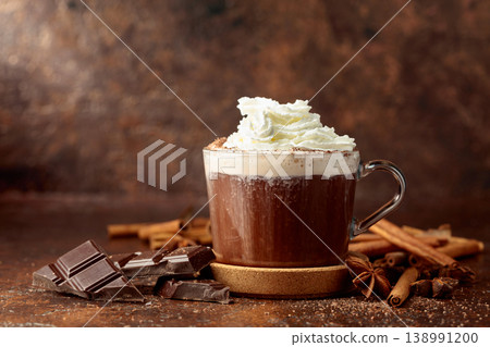 Hot chocolate with ingredients on a brown table. 138991200