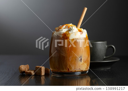Iced coffee with whipped cream and caramel sauce and cup of black coffee. Iced coffee with whipped cream and caramel sauce and cup of black coffee. 138991217