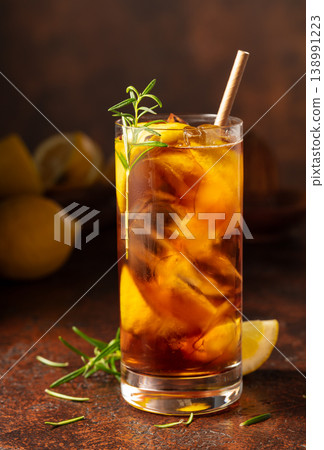 Iced tea or cocktail with ice, rosemary and lemon slices. Iced tea or cocktail with ice, rosemary and lemon slices. 138991223