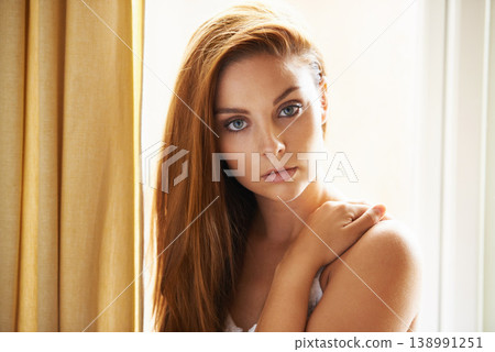 Hair care, portrait or model by window with beauty, skincare or results for glow, shine or collagen. Aesthetic, face or serious woman with cosmetics for treatment, healthy texture or growth in home Hair care, portrait or model by window with beauty, skincare or results for glow, shine or collagen. Aesthetic, face or serious woman with cosmetics for treatment, healthy texture or growth in home 138991251
